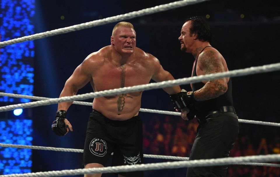 Brock Lesnar, left, and The Undertaker, wrestle during
