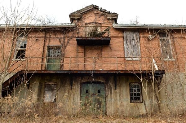 Building 123 sits abadoned, with its roof collapsing,