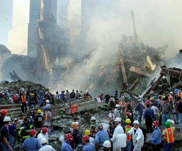 Rescue workers and volunteers remove debris at the