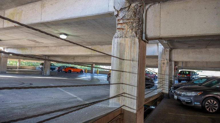 Cracks in support columns and beams are seen at the...