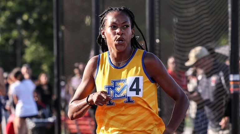 East Meadow's Zaria Hall wins the 800 meter run during day...