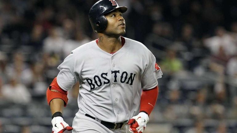 Carl Crawford of the Boston Red Sox watches the flight...