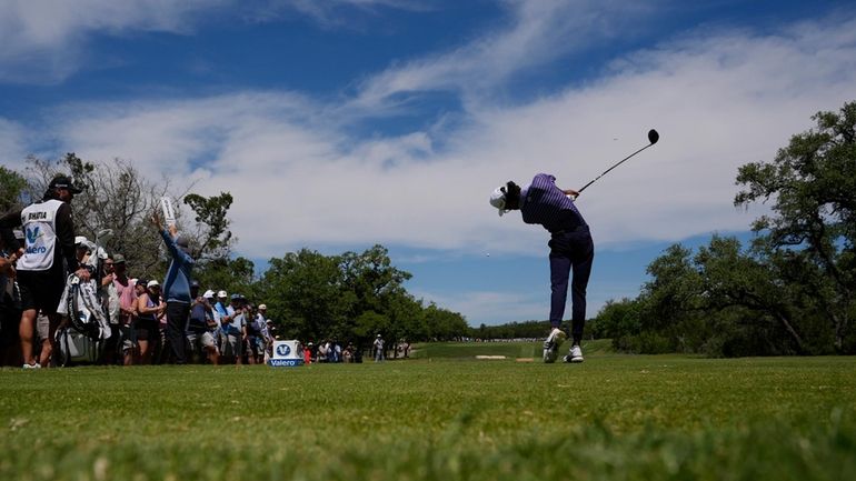 Akshay Bhatia hits his tee shot on the ninth hole...