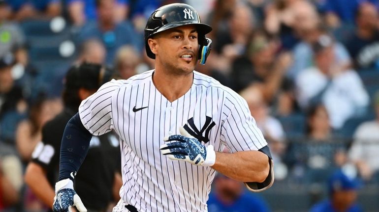 Giancarlo Stanton of the New York Yankees singles in the...