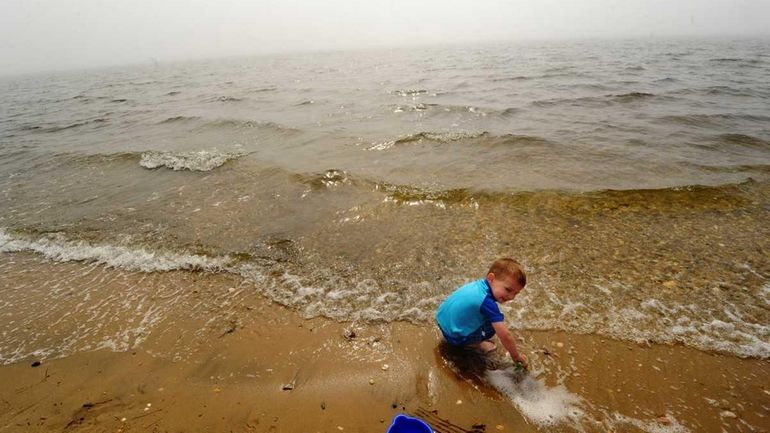 Three-year-old David Martinelli enjoys an unseasonably warm day at Heckscher...