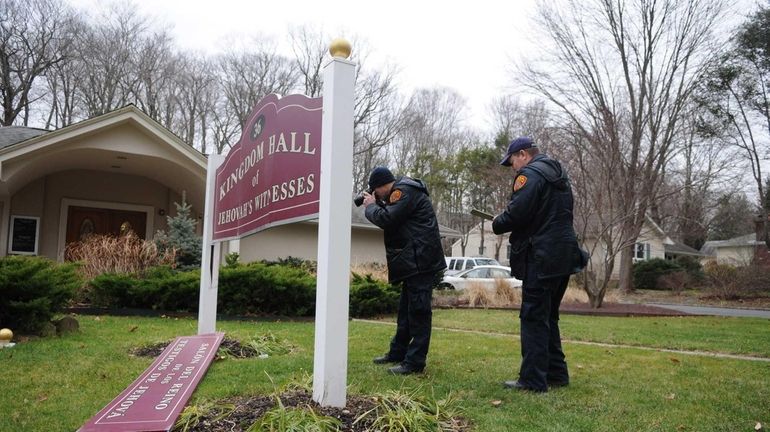 A crime scene investigator probes criminal mischief to a sign...