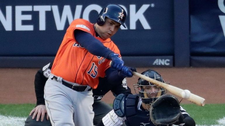 The Astros' Carlos Beltran hits a double during Game 4...