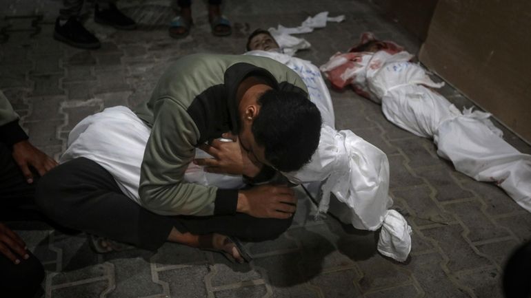 A Palestinian youth mourns his relative killed in the Israeli...