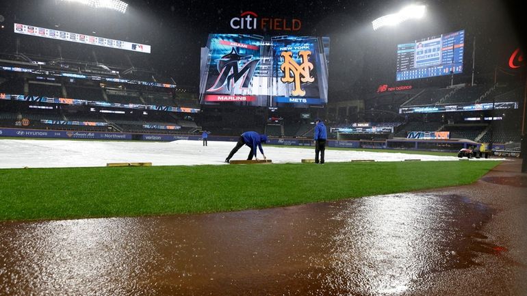 The tarp is on the field during a rain delay...