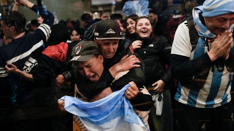 Fans of Argentina react after their team defeated Colombia at...