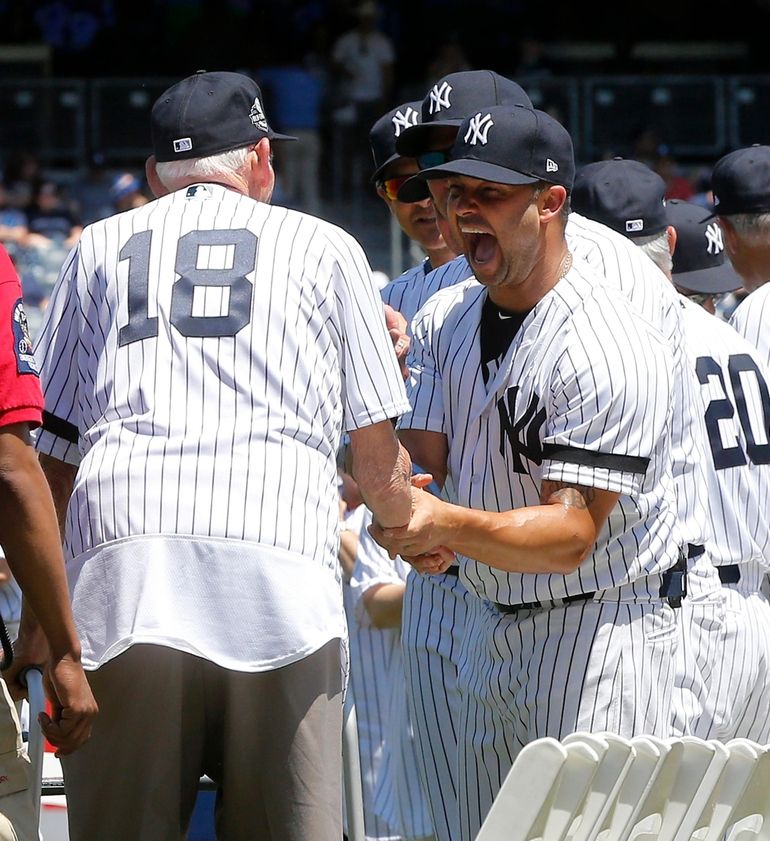 New York Yankees' Nick Swisher, left, greets Johnny Damon at the