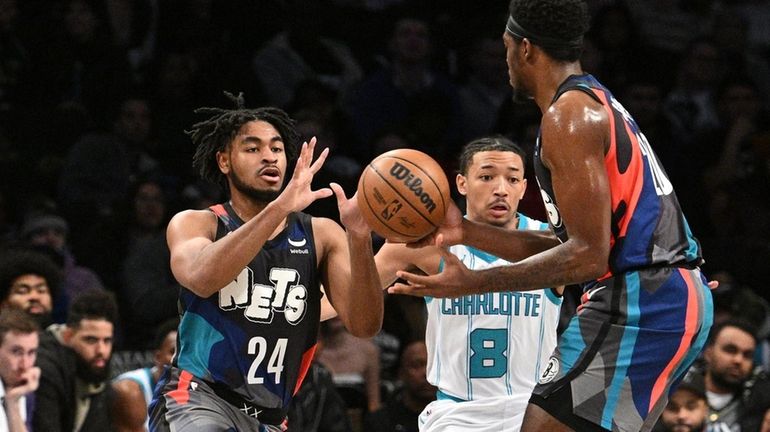 Nets guard Cam Thomas takes a pass from center Day'Ron...