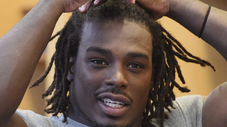 New York Giants linebacker J.T. Thomas speaks to the media...