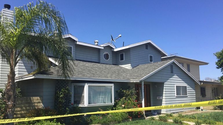 Tape surrounds the home occupied by Stephen Beal in Long...