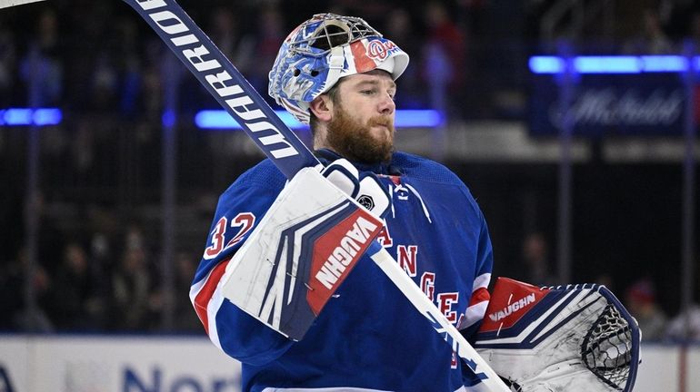 Rangers goaltender Jonathan Quick skates to the net after a...