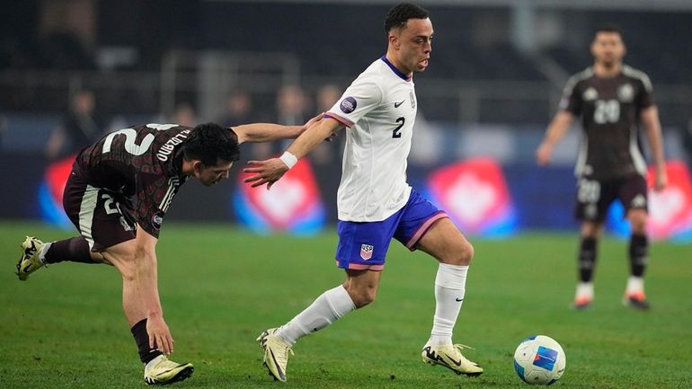 United States defender Sergino Dest dribbles past Mexico forward Hirving...