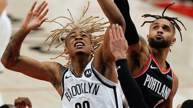 Nets forward Nicolas Claxton, left, and Trail Blazers guard Gary...