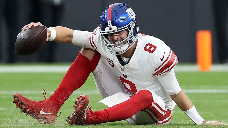 Daniel Jones of the Giants reacts after falling down in the...