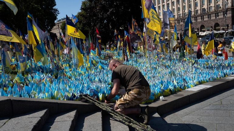 A veteran pays his respect at a makeshift memorial for...