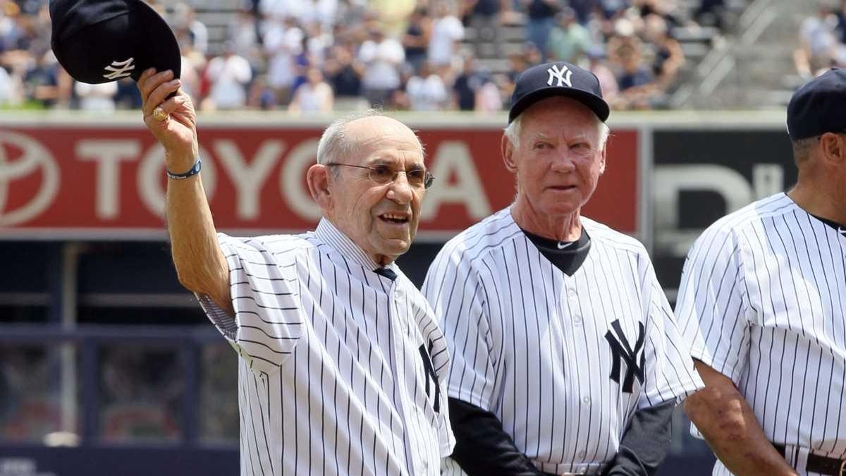 New York Yankees Hall of Famers Yogi Berra and Whitey Ford (R) reacts to  fan's cheers on a golf cart during Old-Timers Day ceremonies before the  Yankees played the Tampa Bay Rays