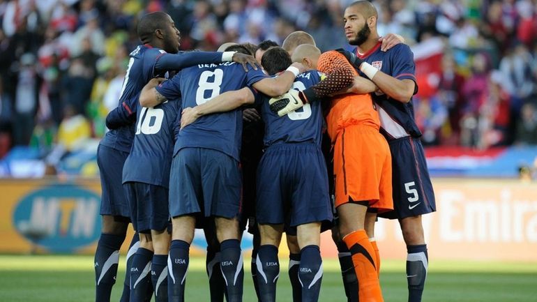 Oguchi Onyewu of the United States, right, looks up as...