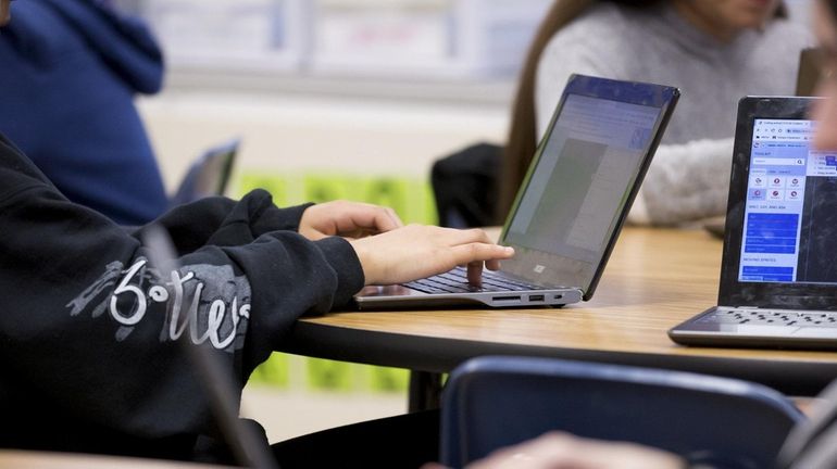 Students in a seventh-grade class at Elwood Middle School use...