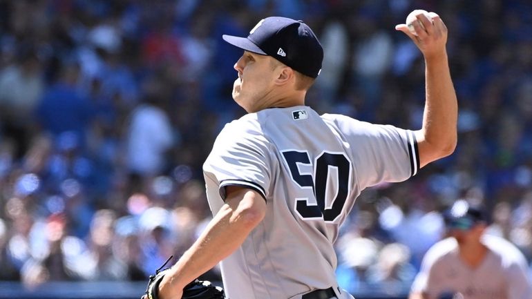 New York Yankees starting pitcher Jameson Taillon throws to a...