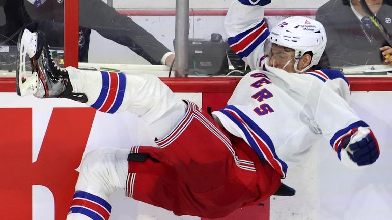 The Senators' Mathieu Joseph checks the Rangers' Filip Chytil during the third period...