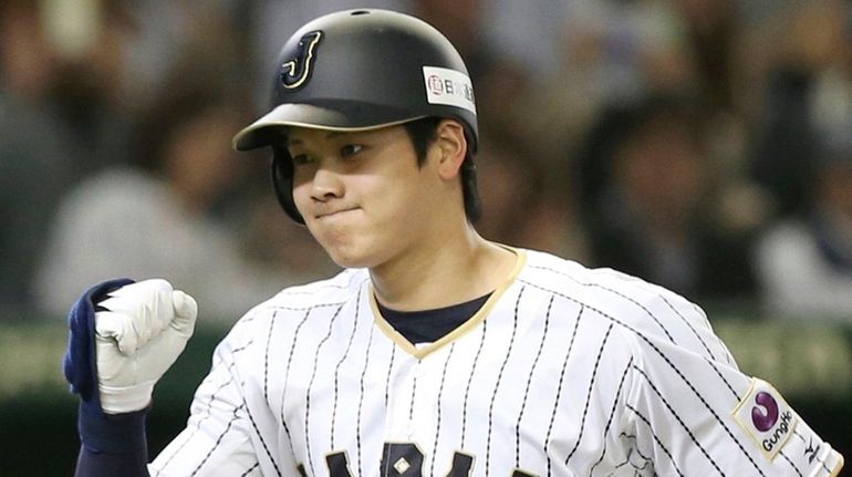 Japan's Shohei Ohtani reacts after hitting a solo home run...