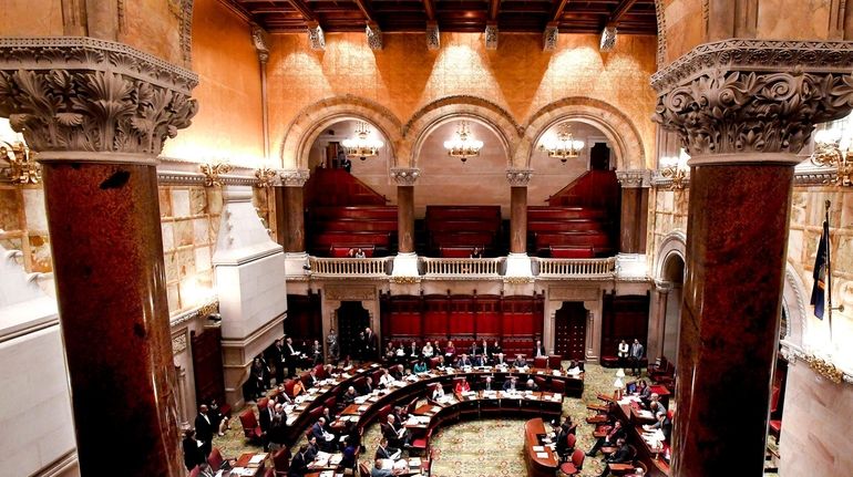 Members of the State Senate debate budget bills at the...