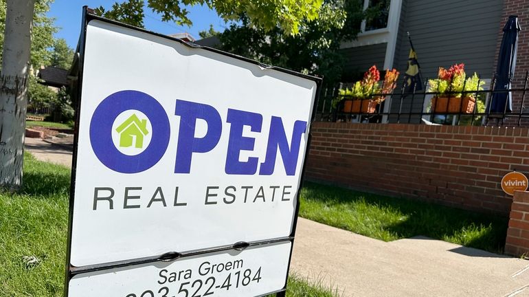 A sign stands outside a home for sale in the...