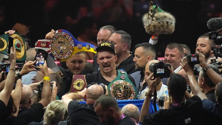 Ukraine's Oleksandr Usyk celebrates after beating Britain's Tyson Fury in...