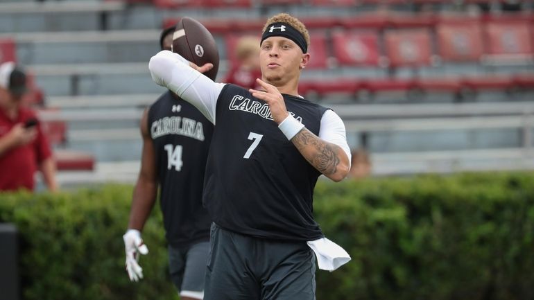 South Carolina quarterback Spencer Rattler (7) warms up before an...