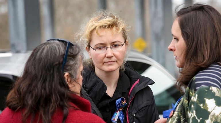 Justyna Zubko-Valva, center, the mother of the late Thomas Valva,...