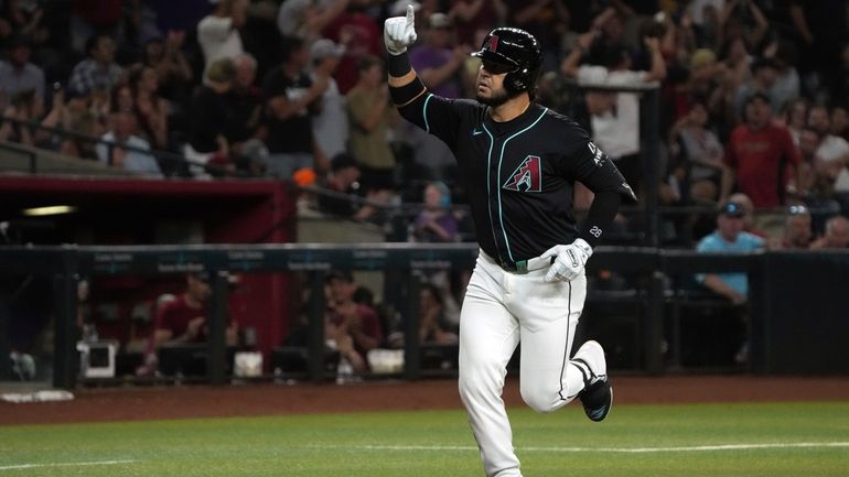 Arizona Diamondbacks' Eugenio Suárez celebrates after hitting a two-run home...