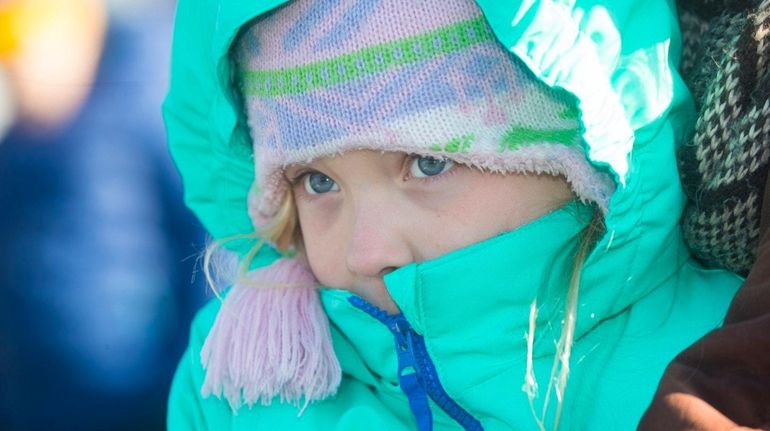 LeNeve Zuhoski, 8, of Southold is bundled up against the...