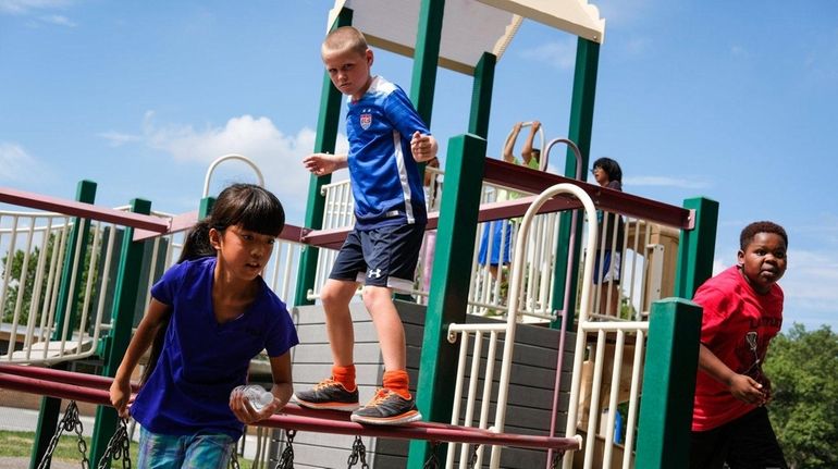 From left, fifth-graders Lilyanna Driscoll, 9, Aidan Jennings, 10, and...