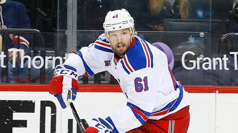 Rick Nash #61 of the New York Rangers skates against...