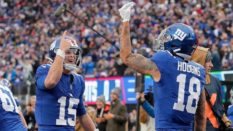 Isaiah Hodgins of the Giants celebrates his second-quarter touchdown against the Patriots with...