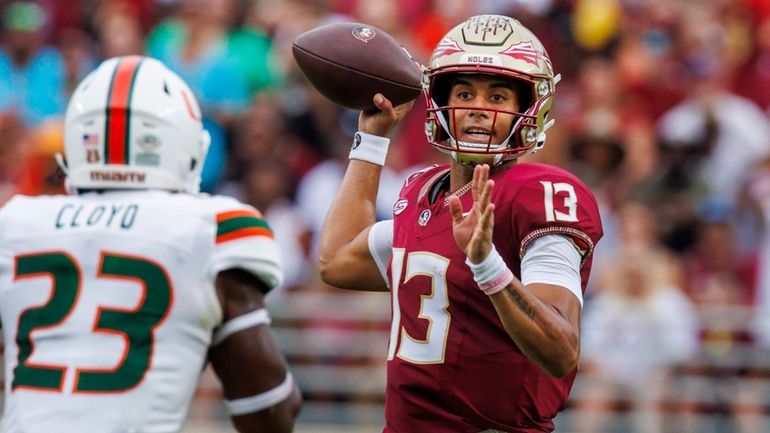 Florida State quarterback Jordan Travis (13) looks for a receiver...