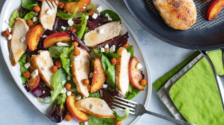 This salad features chicken breast, seared peaches and spiced chickpeas...