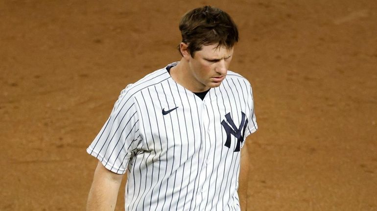 Yankees second baseman DJ LeMahieu grimaces as he walks off...