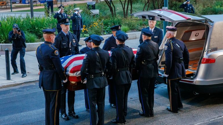 Pallbearers prepare to carry body of fallen Philadelphia police officer...