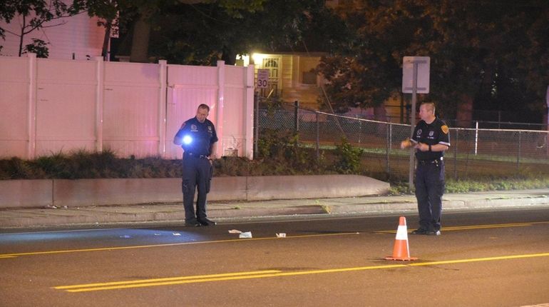 Suffolk County police investigate the scene where a male pedestrian...