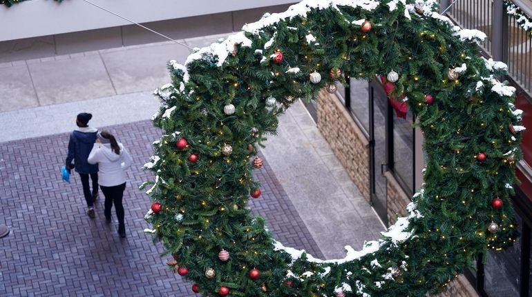 Shoppers wear face masks while in search of after-Christmas bargains...