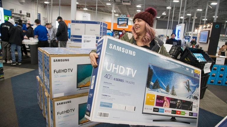 Elaina Brzostek, 19, of East Islip, grabs a flat screen...