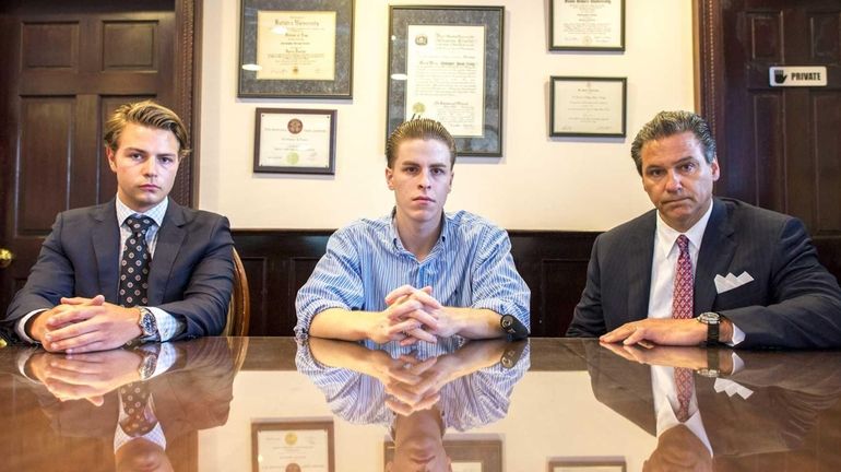 John Dowling III, paralegal at left, sits with Christopher Cassar,...