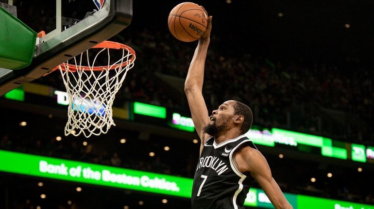 The Brooklyn Nets' Kevin Durant dunks during the first half...