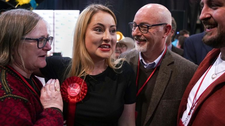 Labour Party candidate Gen Kitchen celebrates with her family after...