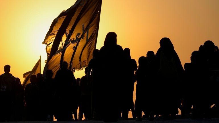 The sun sets as Shiite pilgrims march on their way...